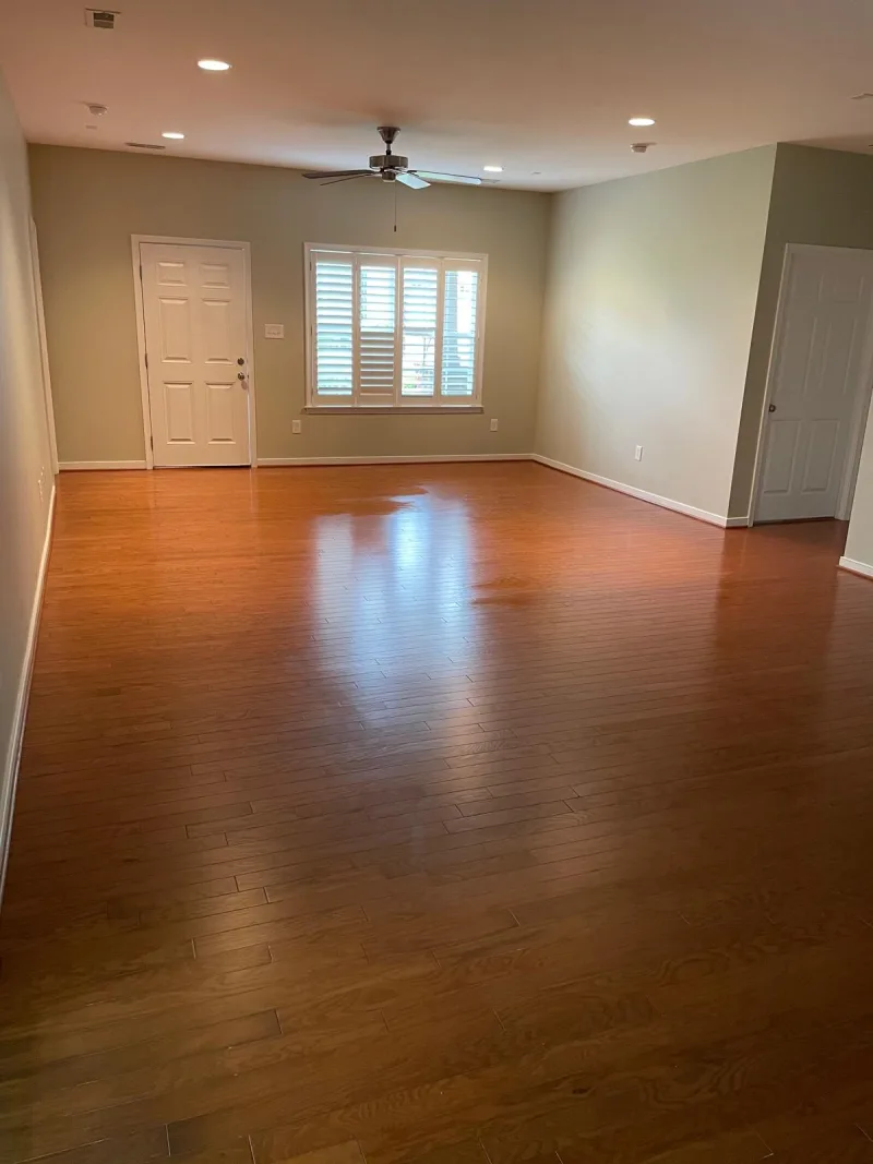Empty living room with clean, shining hardwood floors